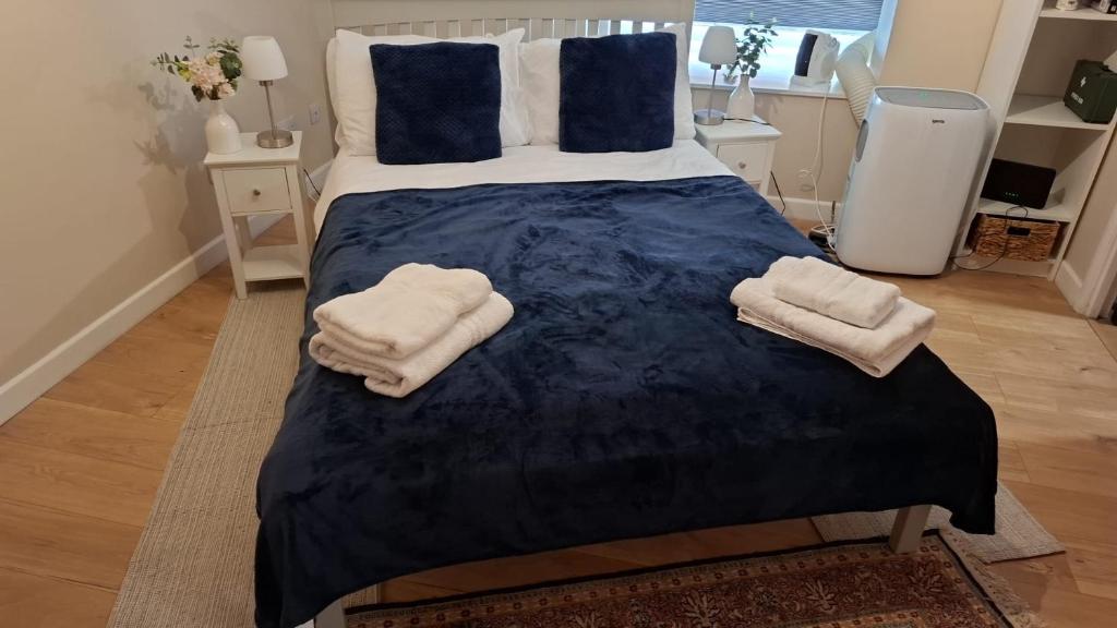 a bedroom with a bed with two towels on it at Elegant Flat in Oxford Center with Parking in Oxford