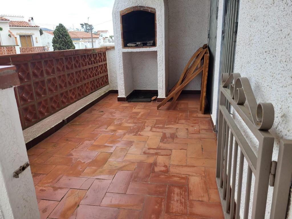 balcón con suelo de madera y TV en Maison dans Résidence piscine, en Roses