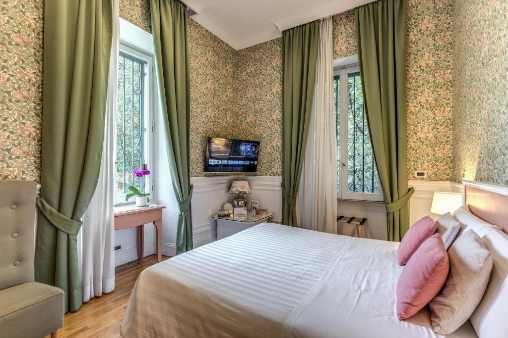 Postel nebo postele na pokoji v ubytování Mangili Garden Hotel