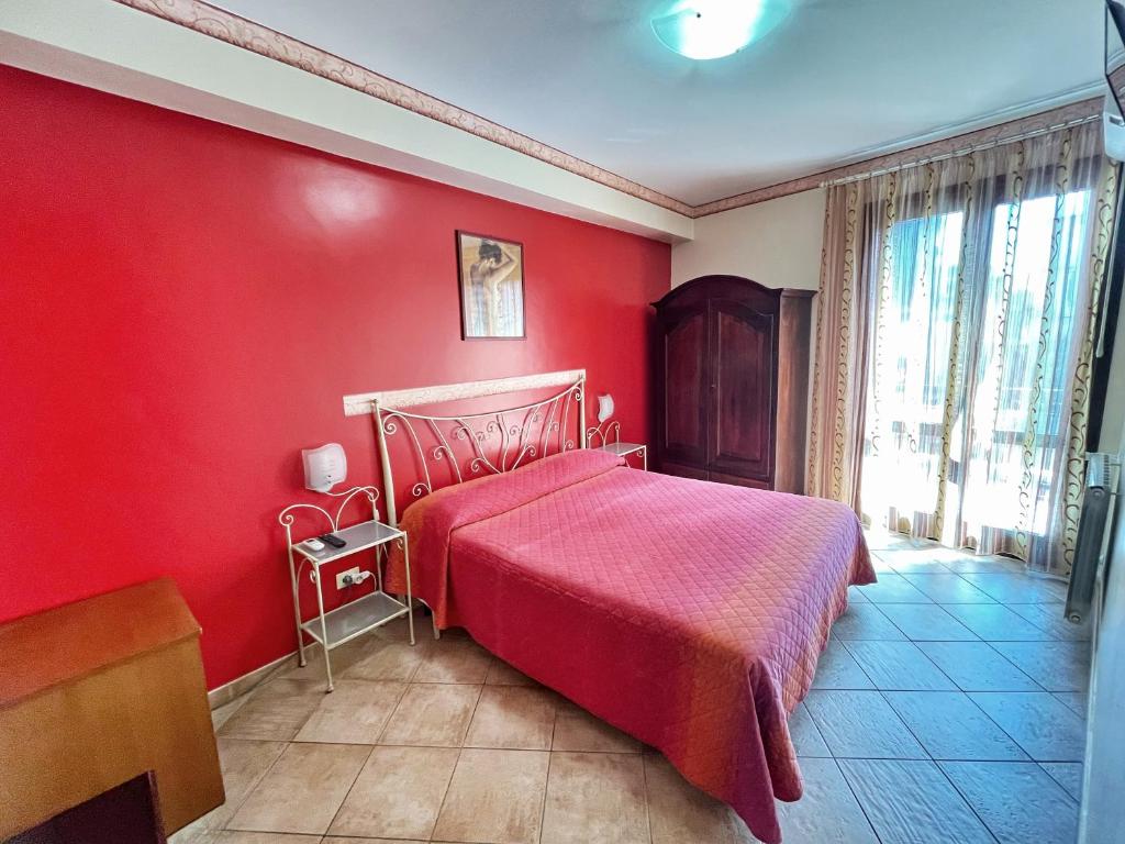Postel nebo postele na pokoji v ubytování B&B Epos Acitrezza