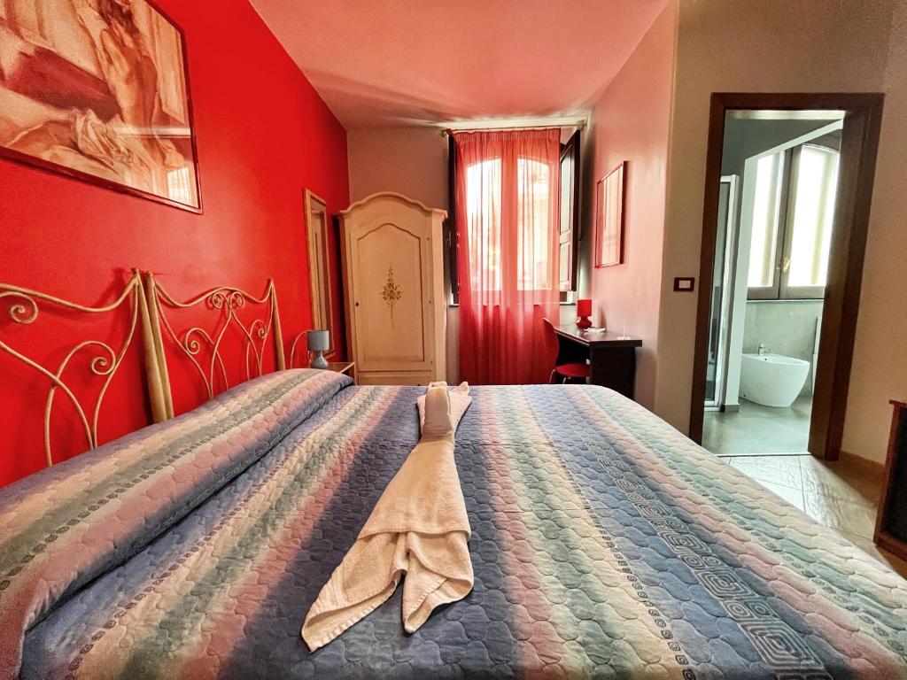 Postel nebo postele na pokoji v ubytování B&B Epos Acitrezza