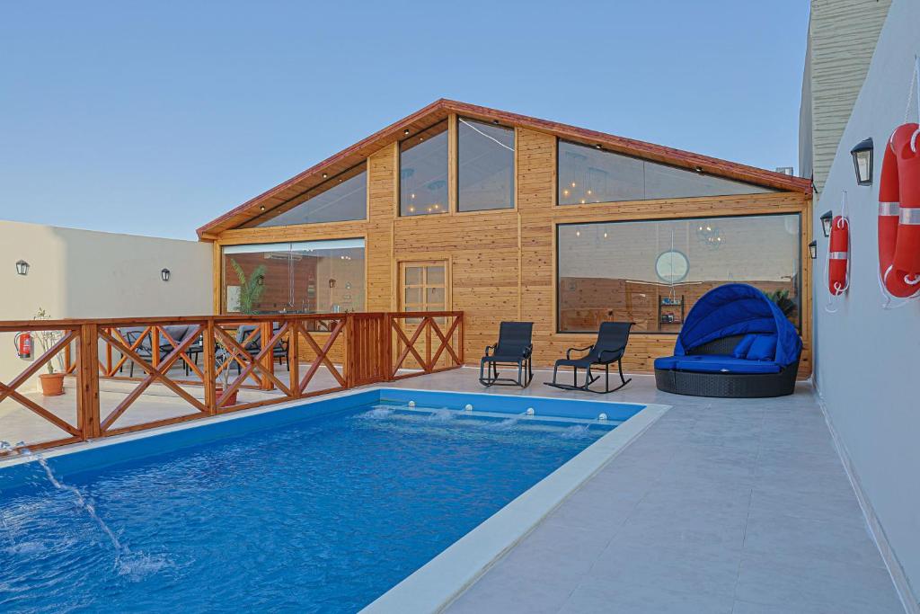 a swimming pool in front of a house at منتجع سي فيو - sea view cottages in Jeddah