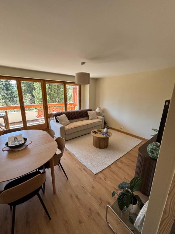 a living room with a table and a couch at Appartement Crans-Montana in Crans-Montana