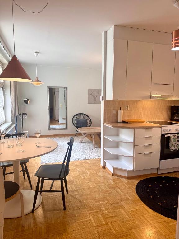 a kitchen and living room with a table and a dining room at Nordic Sauna Experience in Helsinki