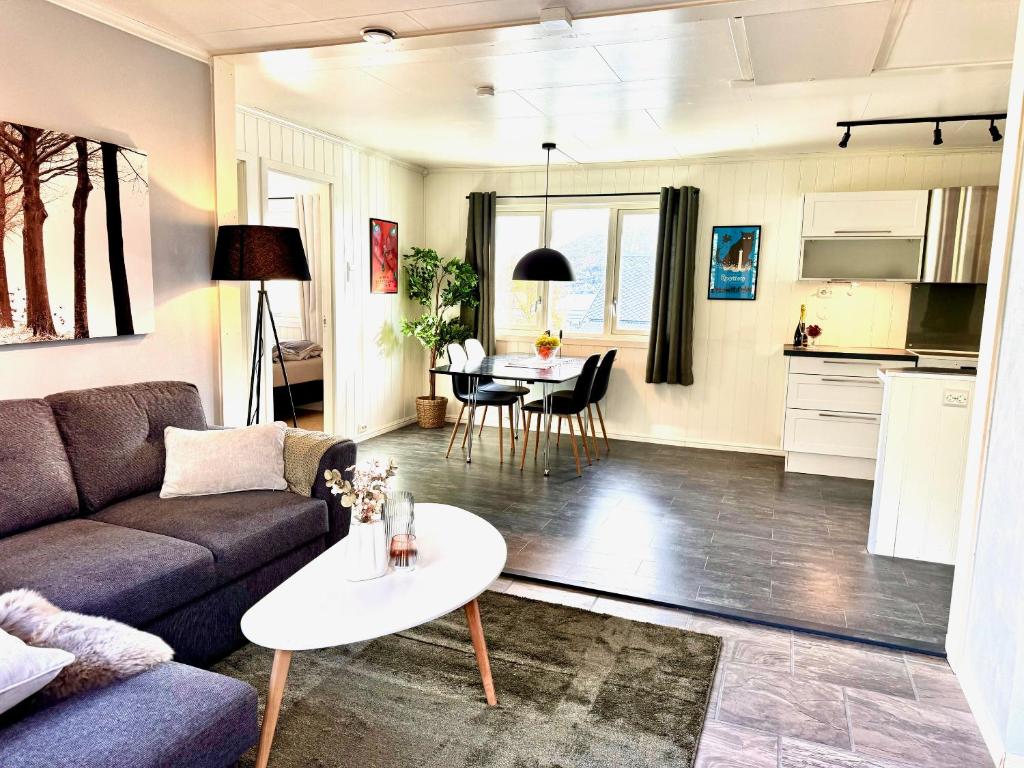 a living room with a couch and a table at Casa Troll in Tromsø