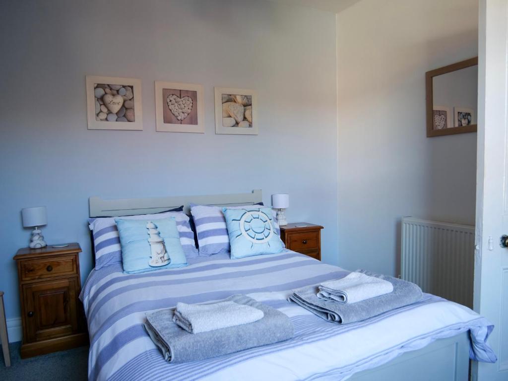 a bedroom with a bed with towels on it at Seashells in Bridlington