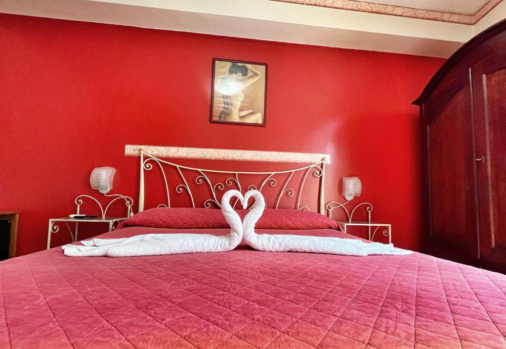 Postel nebo postele na pokoji v ubytování B&B Epos Acitrezza
