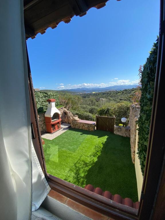 a view of a garden from a window of a house at Casa KePi in Olbia