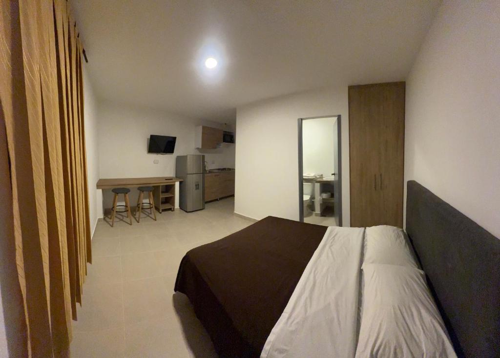 a bedroom with a bed and a table in a room at apartamentos villa 1blanca in Popayan