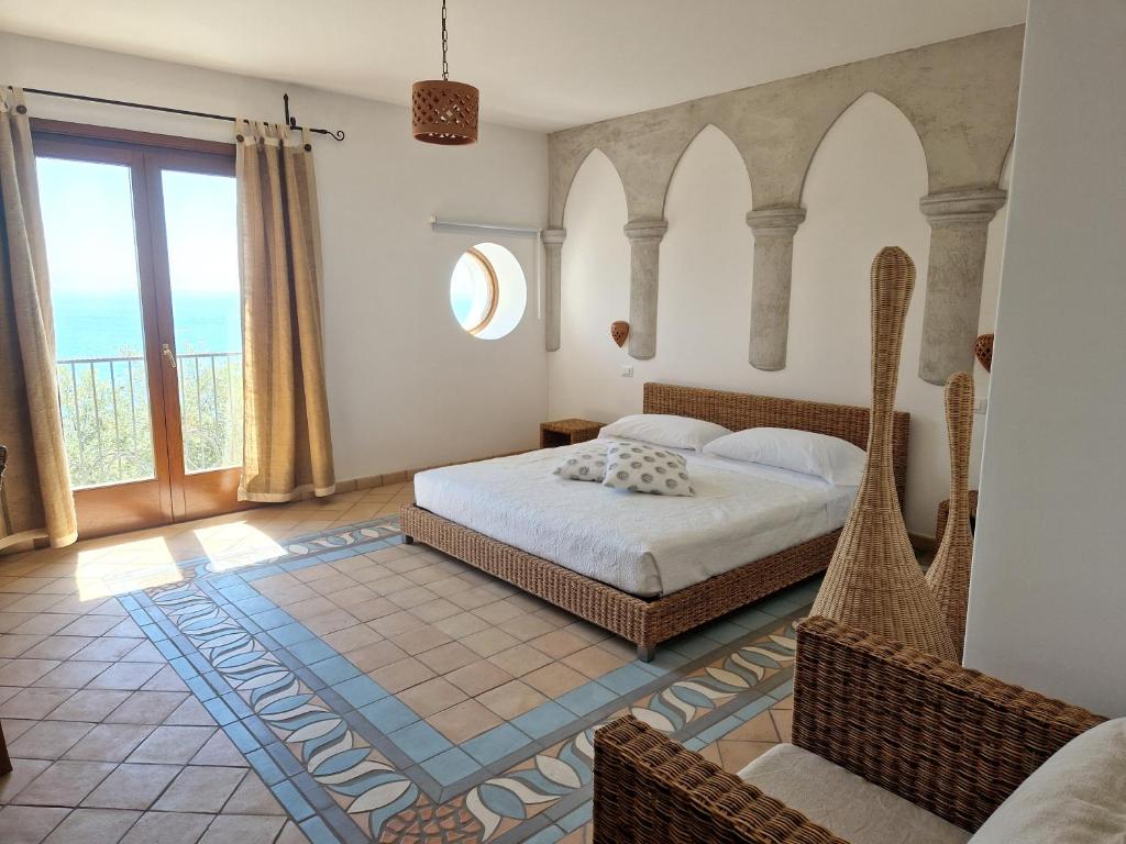 a bedroom with a bed and a large window at HOLIDAY double in Praiano