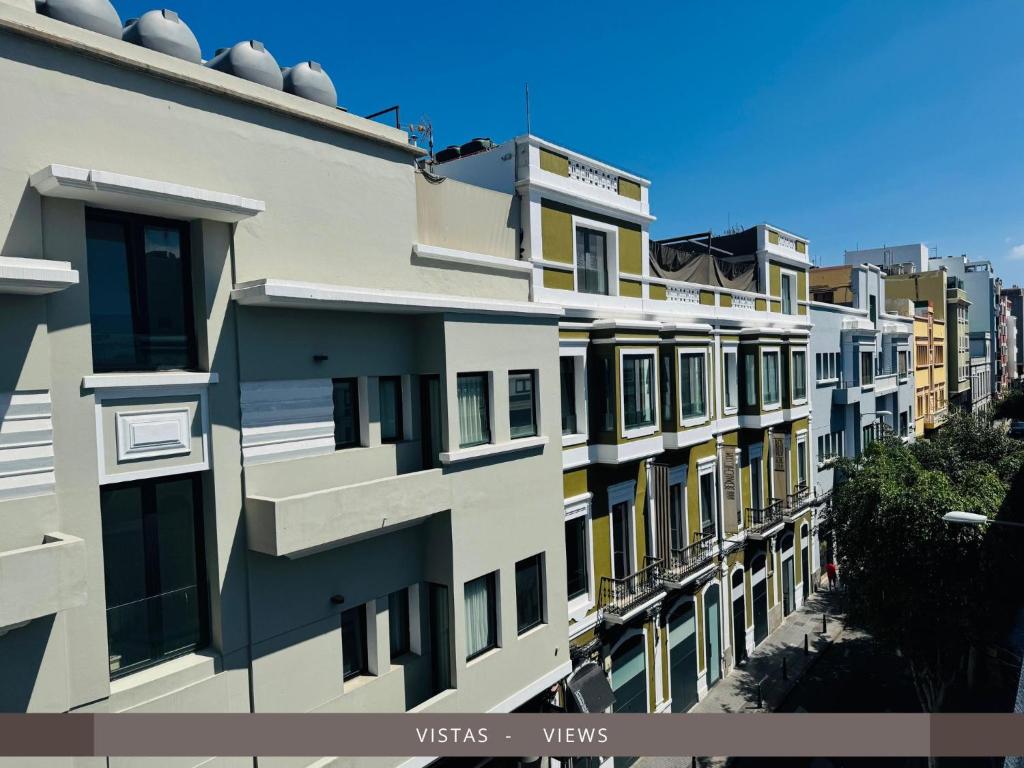 a row of apartment buildings on a street at Hotel Kasa in Las Palmas de Gran Canaria