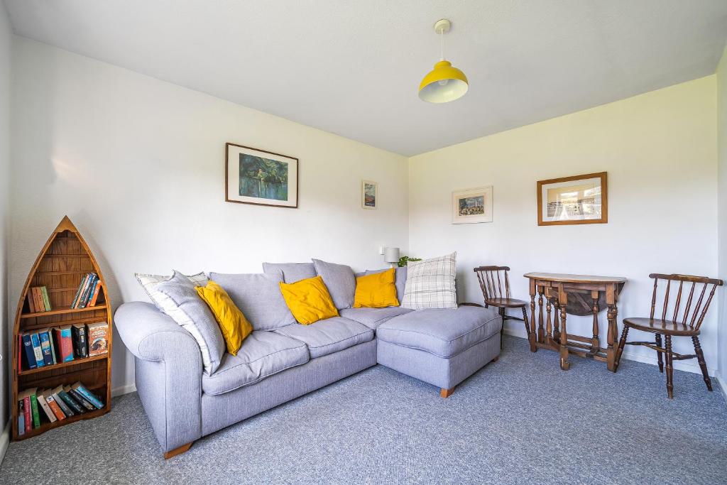 a living room with a couch and a table at Spacious one bed apartment in a quiet leafy close. in Barnstaple