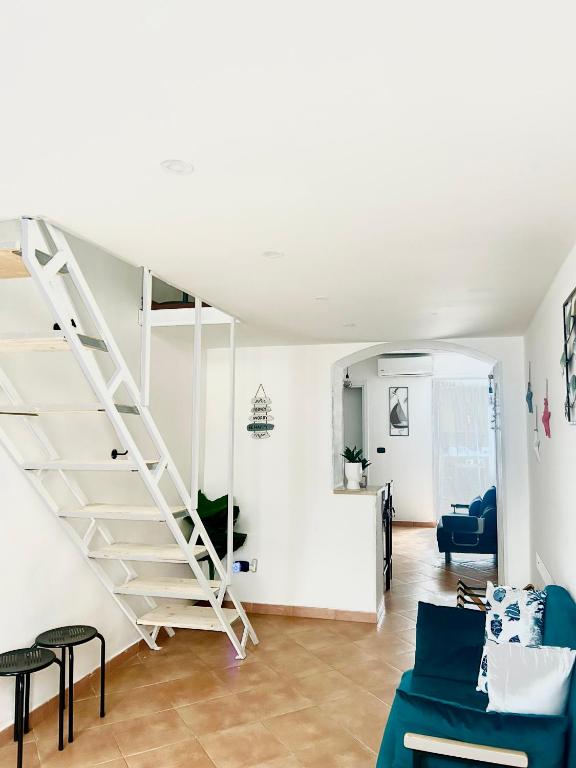 a white staircase in a living room with a blue couch at Savona Sea in Bari