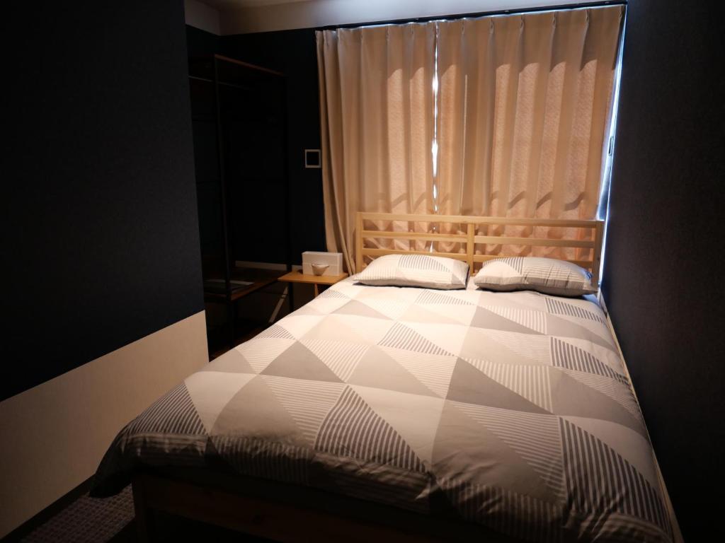 Postel nebo postele na pokoji v ubytování ForYou Honancho 方南町