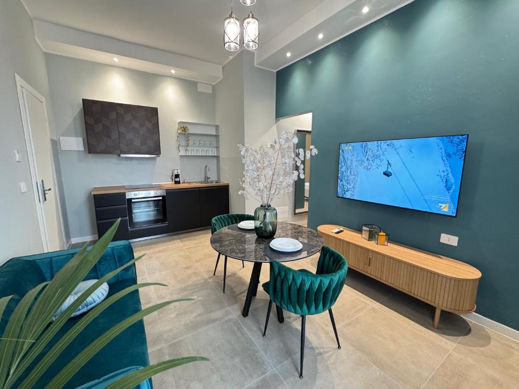 a living room with a table and a tv on a wall at Alan'S Home in Terni