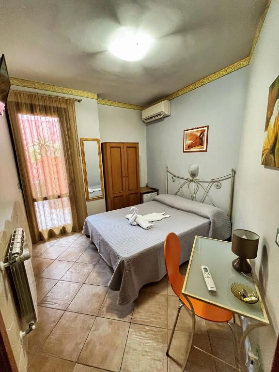 Postel nebo postele na pokoji v ubytování B&B Epos Acitrezza