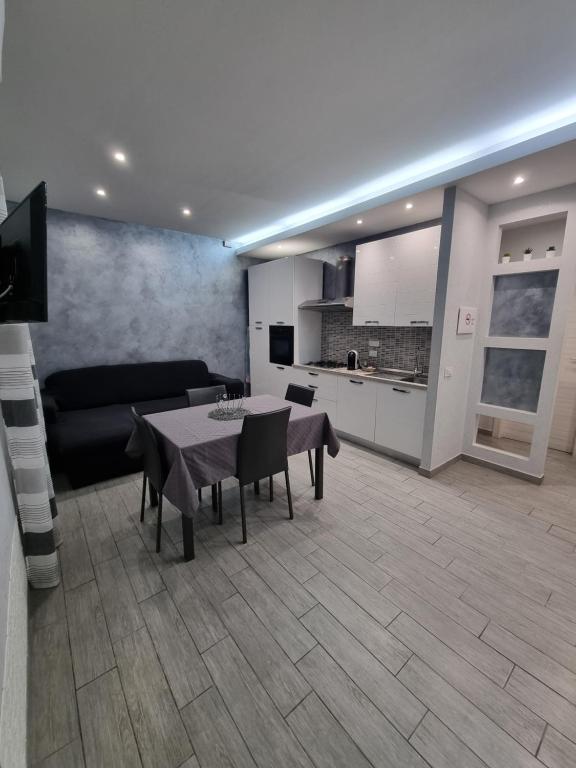 a living room with a table and a kitchen at Holiday Home B&M in Pozzallo