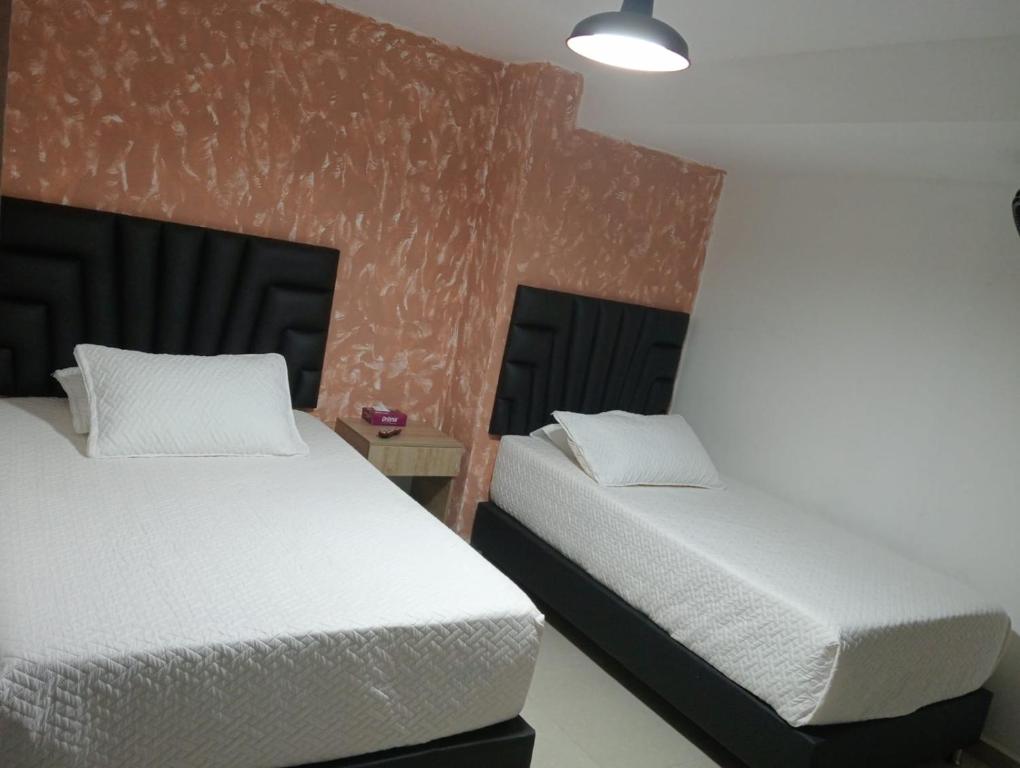 Postel nebo postele na pokoji v ubytování Hotel Lesus