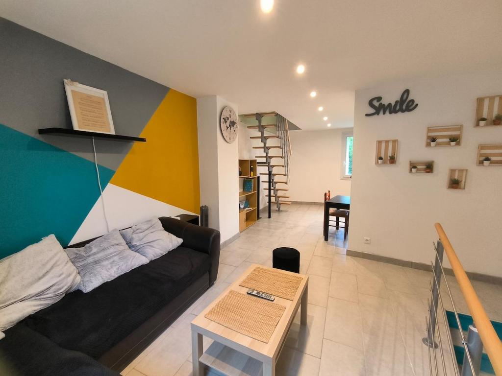 un salon avec un canapé et une table dans l'établissement Charmante maison de village, à Suze-la-Rousse