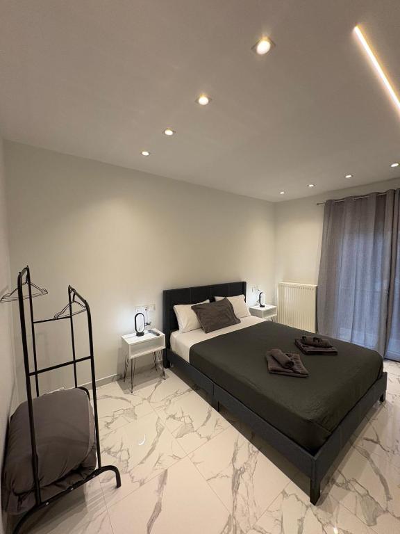 a bedroom with a bed and a chair in it at Αικατερίνα in Kozani
