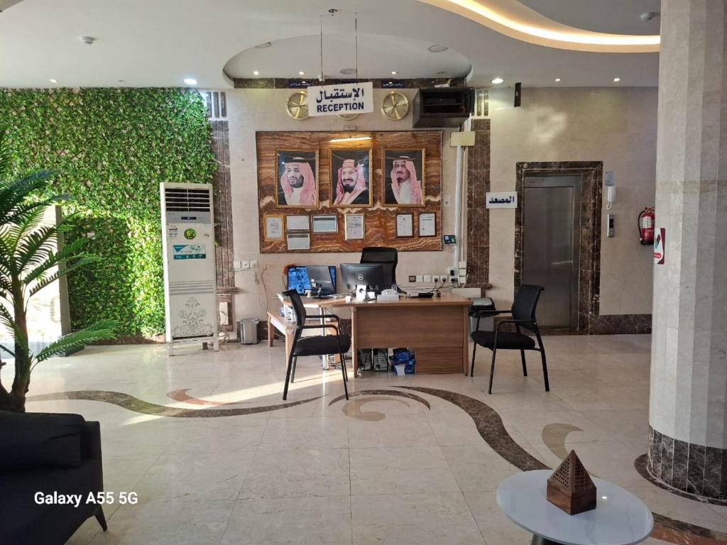 an office with a desk and chairs in a lobby at بست تريب ميلانو للشقق المخدومة in Jeddah
