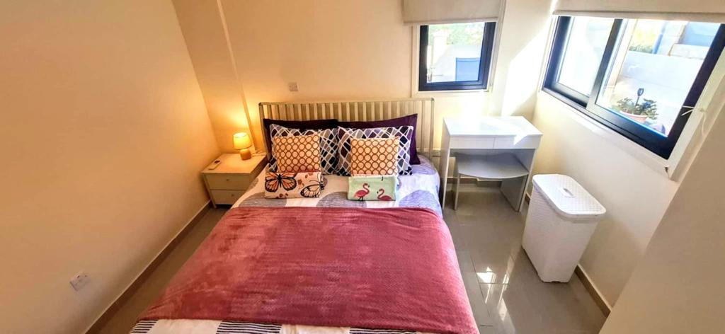 a small bedroom with a bed and a sink at AFRODITI APARTMENTs in Perivolia