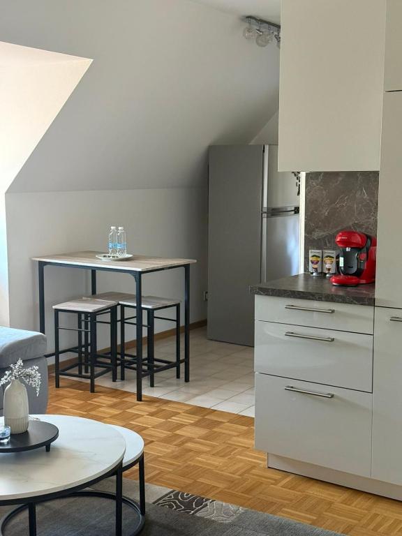 a kitchen with a table and a counter top at Old town comfort and cozy apartment 2 in Dachau