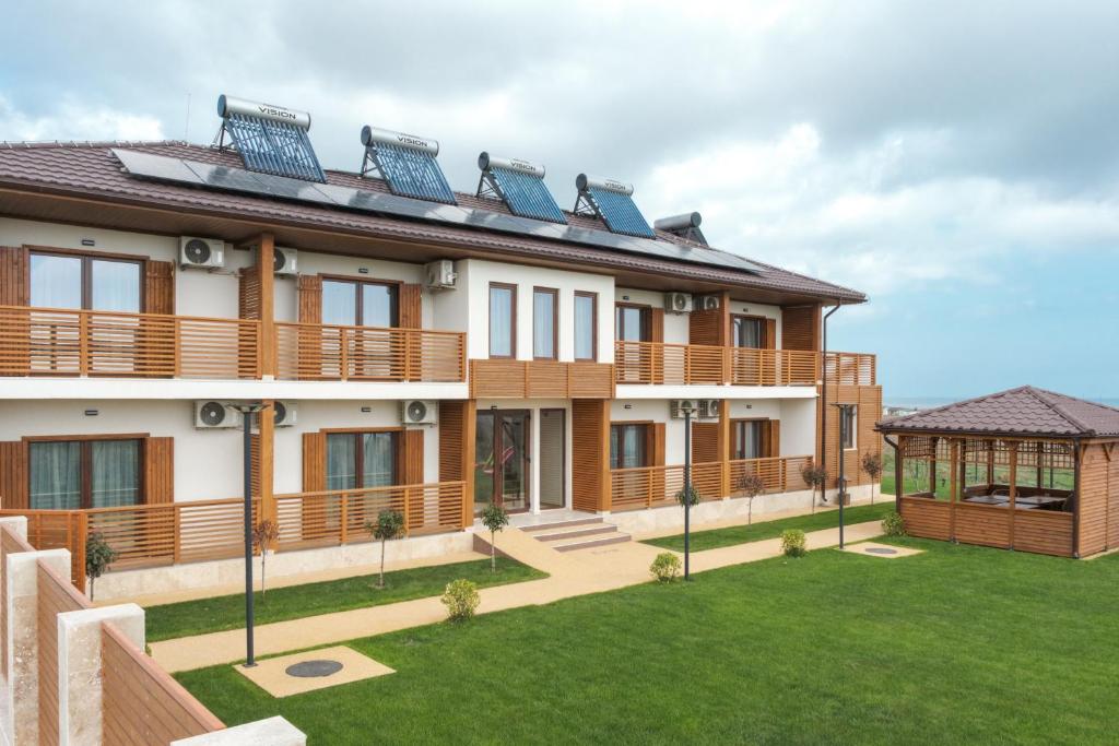 a house with solar panels on the roof at Pensiunea EVIA CORBU in Corbu