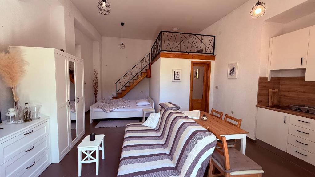 a living room with a couch and a stair case at Apartment Paolo in Senj