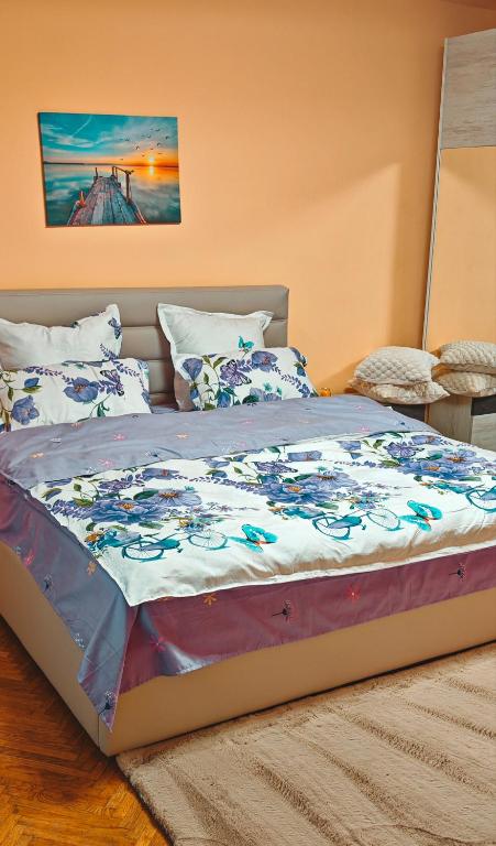 a large bed in a bedroom with a bedspread on it at CozyRent Ocna Mures in Ocna-Mureşului