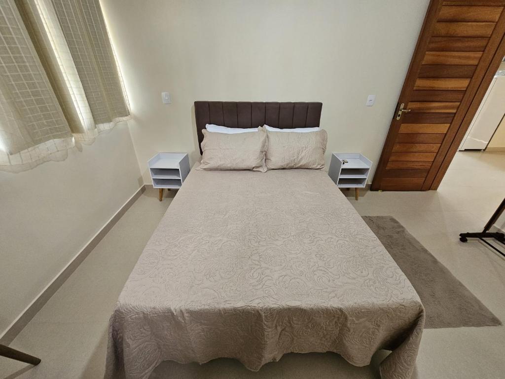 a bedroom with a large bed in a room at Casa Vista da Pedra in Domingos Martins