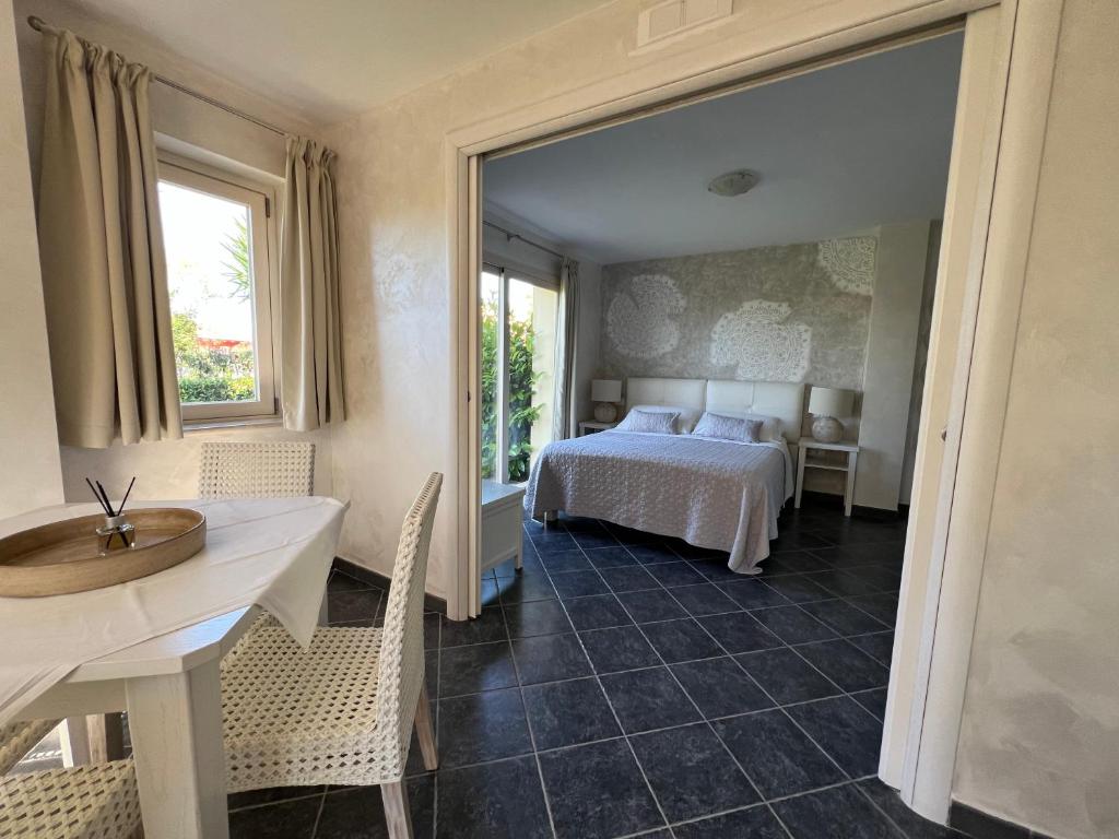 a bedroom with a bed and a table and chairs at Borgo di Santa Barbara in Santa Domenica