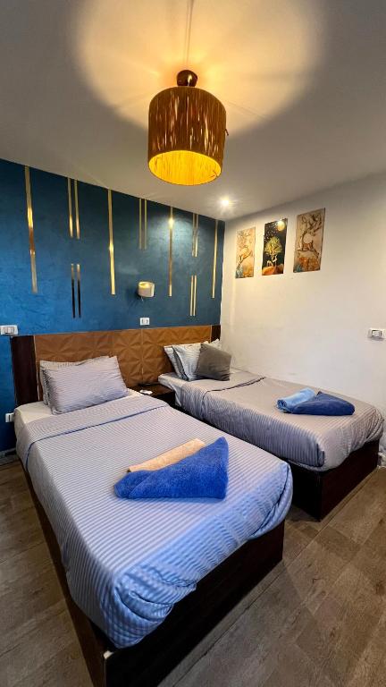 Postel nebo postele na pokoji v ubytování Grand Pyramids Inn
