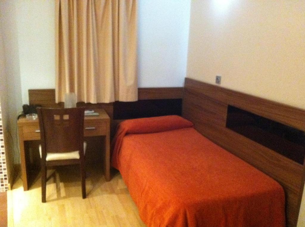 Postel nebo postele na pokoji v ubytování Hotel El Cruce Moraleda