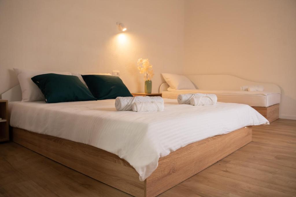 a bedroom with two large beds and a couch at Iris Apartments in Ohrid
