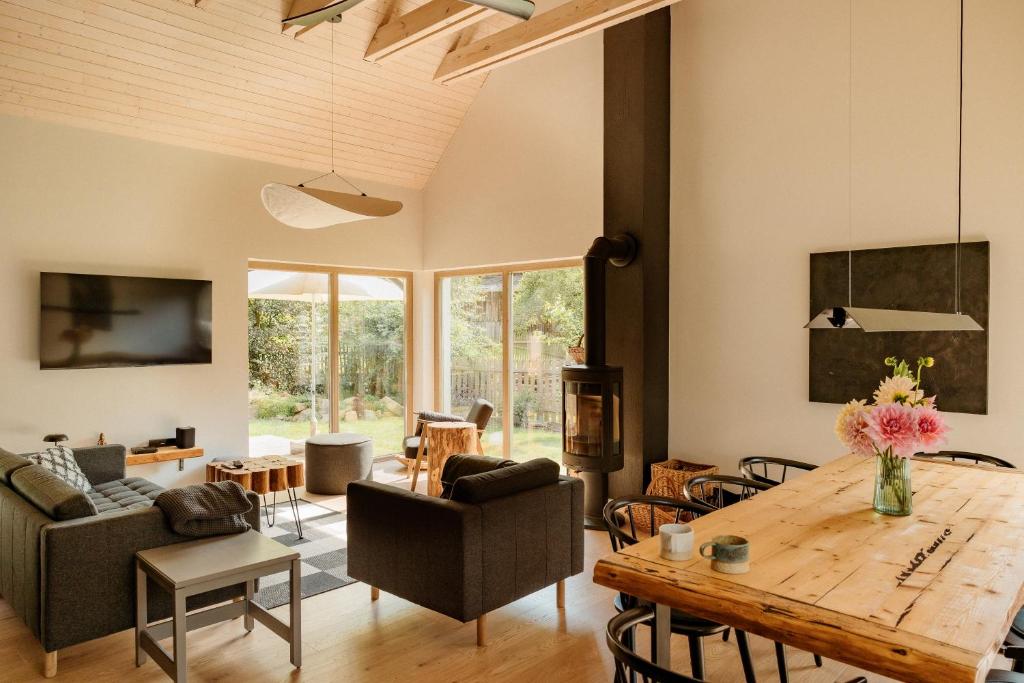 a living room with a wooden table and chairs at Dom w Marczowie in Prezezdziedza