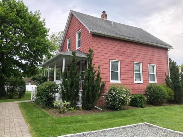 a red house with a gray roof at The Mystic Charmer ,formerly The Charmer in Mystic