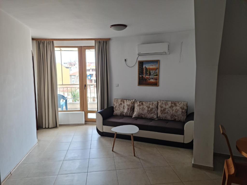 a living room with a couch and a table at Apartment Lermontov in Burgas