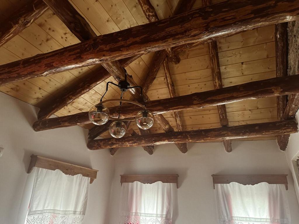 a chandelier hanging from a wooden ceiling in a room at Suite of Bazaar in Gjirokastër