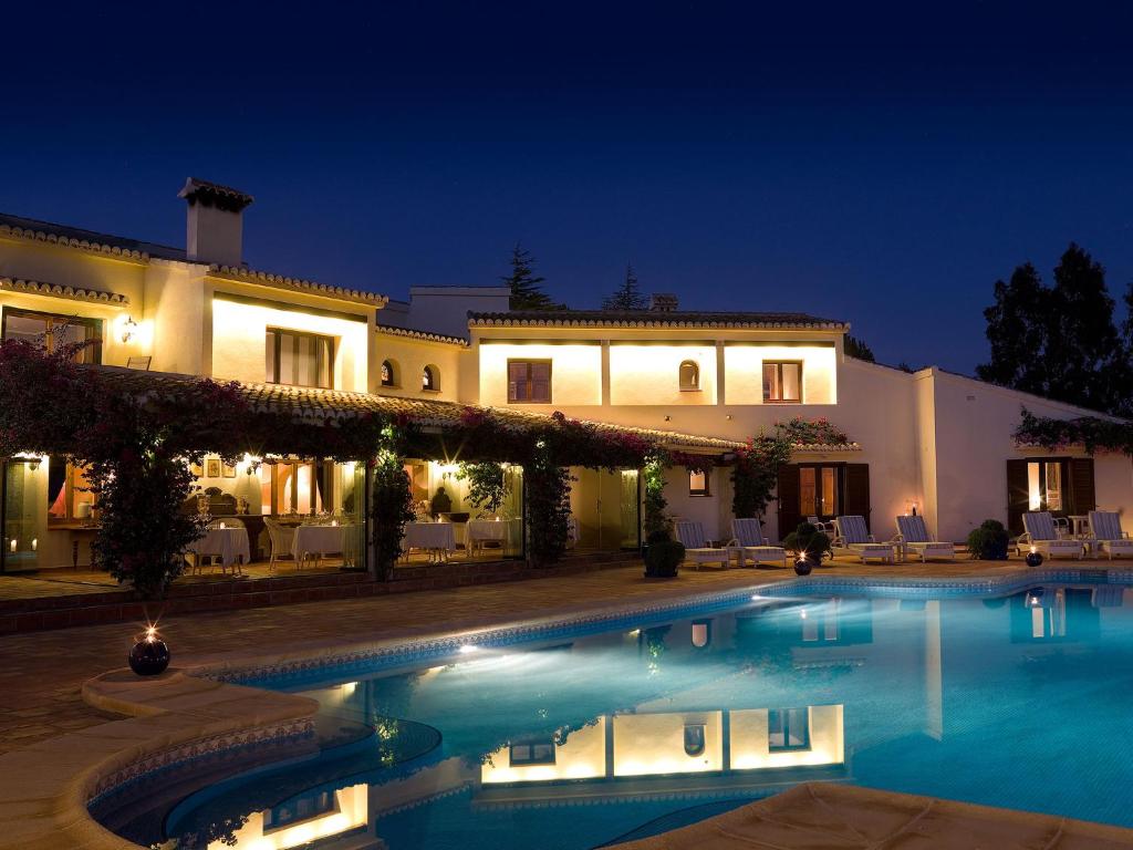 a large house with a swimming pool at night at Boutique Hotel La Madrugada in Benissa