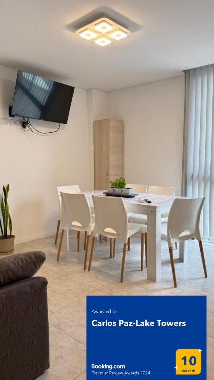 a dining room with a white table and chairs at Carlos Paz-Lake Towers in Villa Carlos Paz