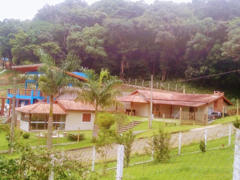 una casa con palme di fronte a una montagna di Casa Casoli - Perfeita para família e amigos a Bueno Brandão
