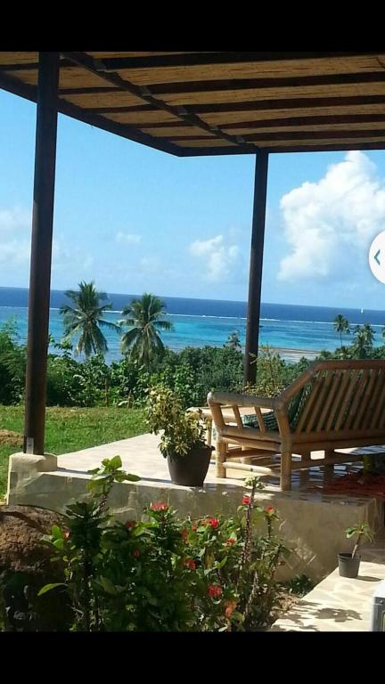 a view of the ocean from a patio with a bench at Ocean Plateau in Motu Tiahura
