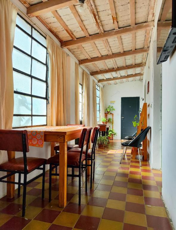 a dining room with a wooden table and chairs at La casa de Angélica in Gualeguaychú