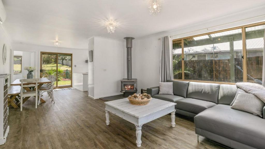 a living room with a couch and a table at Woolamai Waters in Cape Woolamai