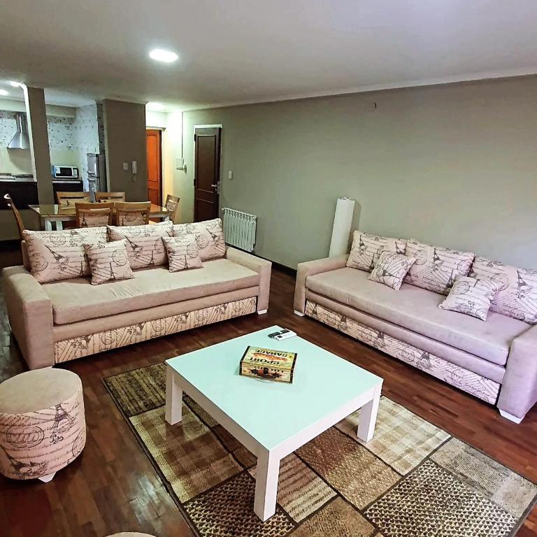 a living room with two couches and a coffee table at Departamento Caseros Centro in Salta