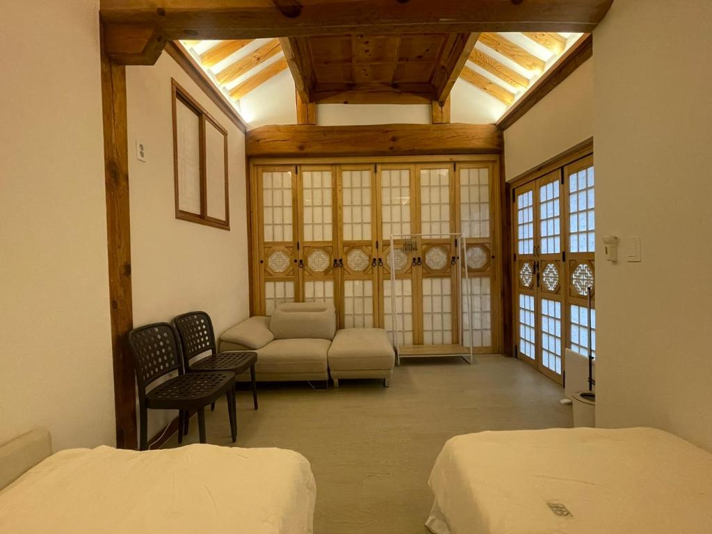 a living room with two beds and a couch at Stay 148 in Seoul