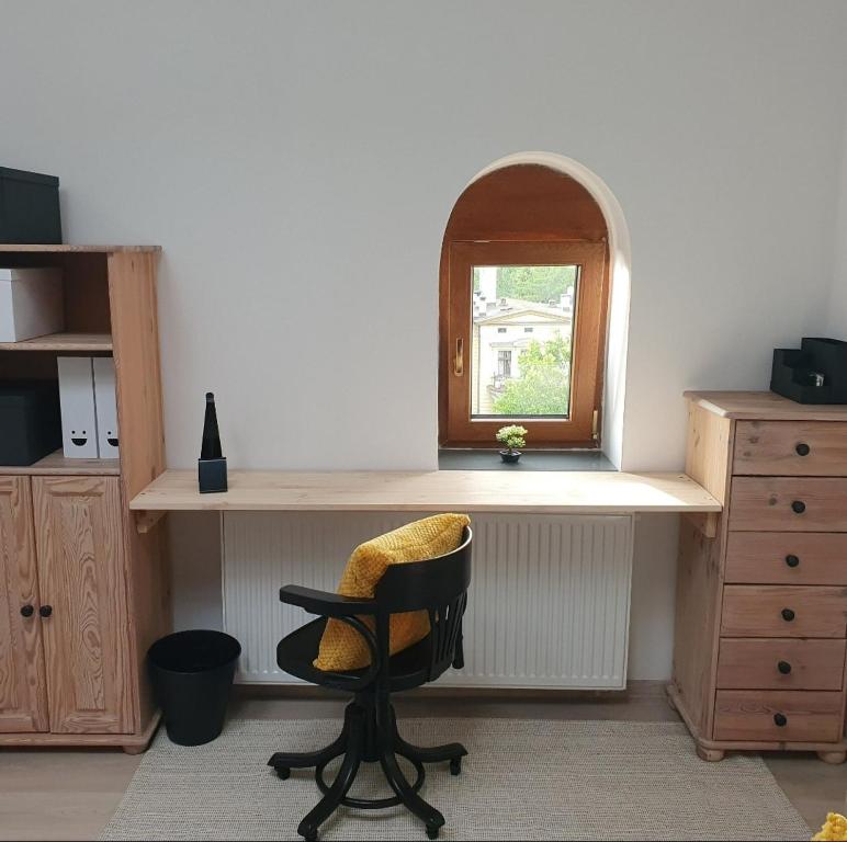 a desk with a chair and a window in a room at Wielkopolska 22 in Szczecin