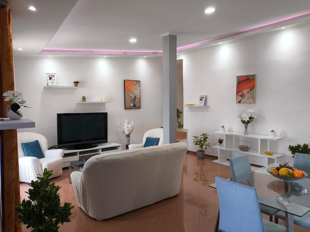 a living room with a couch and a television at Old Town view Apartment in Cidade Velha