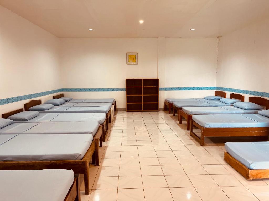 a room with a row of beds in a room at Villa Paraiso Resort & Waterpark in Bokbok